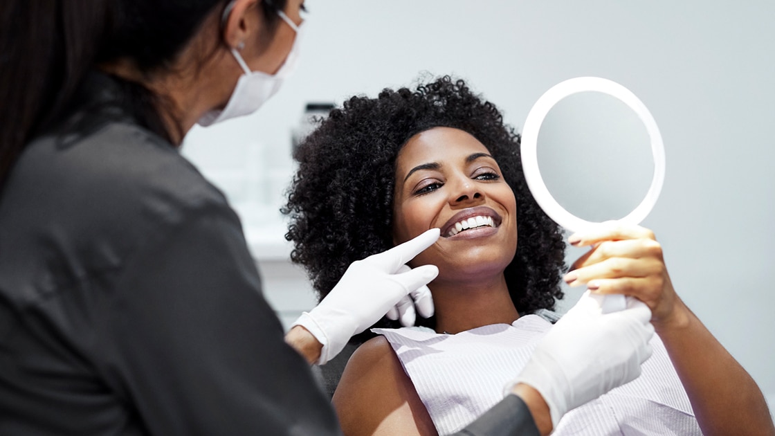 Smilng woman Looking in Mirror